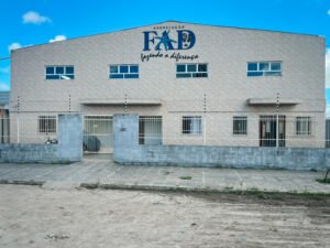 Outside of the FAD community Center in Queimadas Brazil - a large brick building in beige