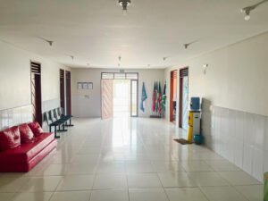 long white hallway with chairs and flags at the FAD community center