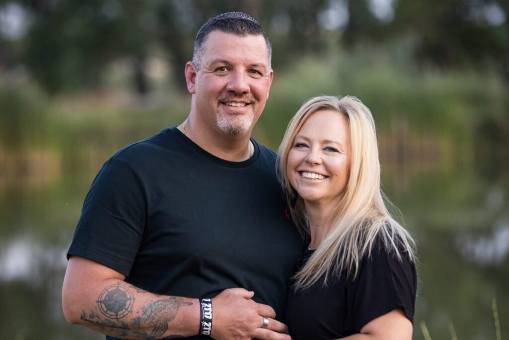 Man and woman posing outdoors
