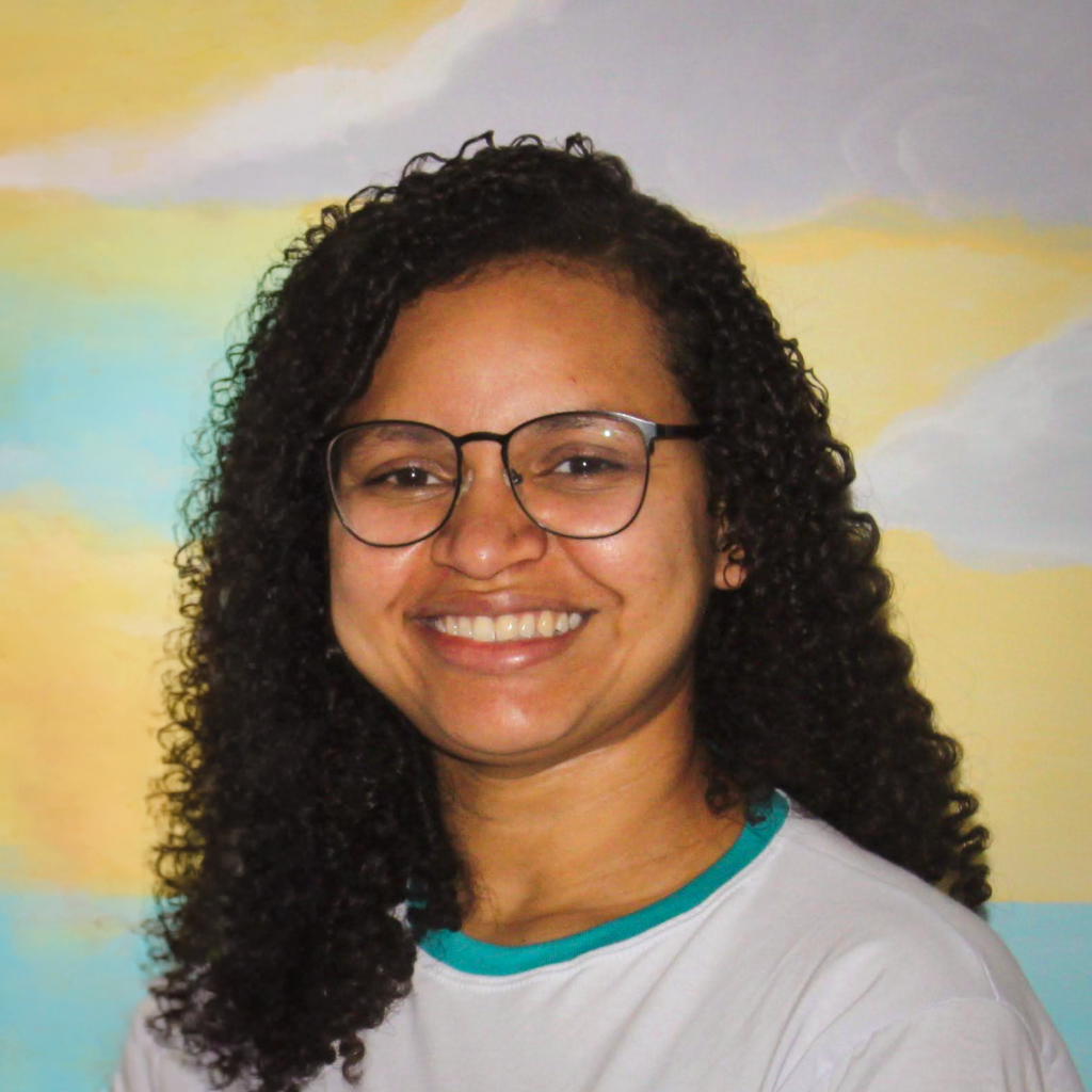 Women with glasses and curly hair smiling at FAD center