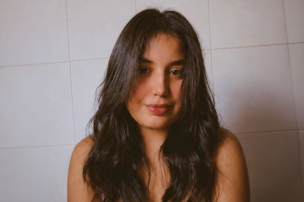 Teen girl with long brown hair smiling