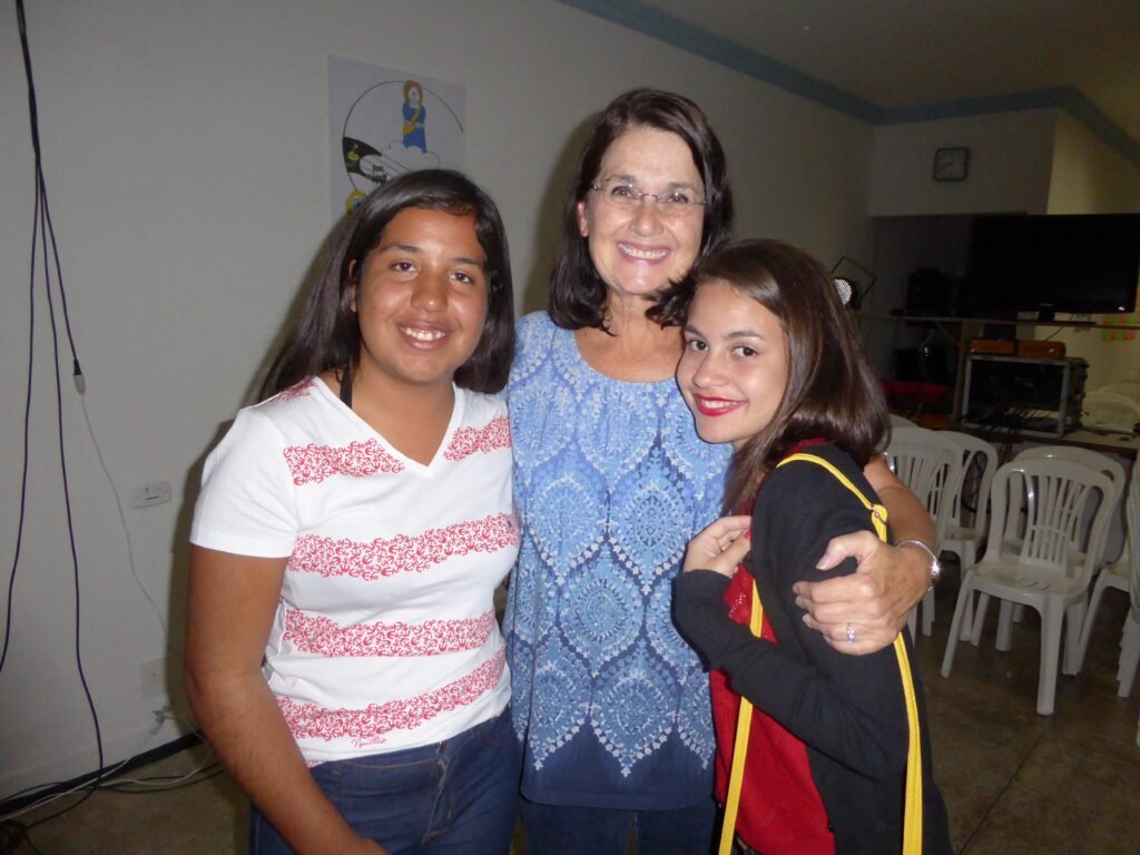 woman posing with 2 young girls at the FAD center in Brazil