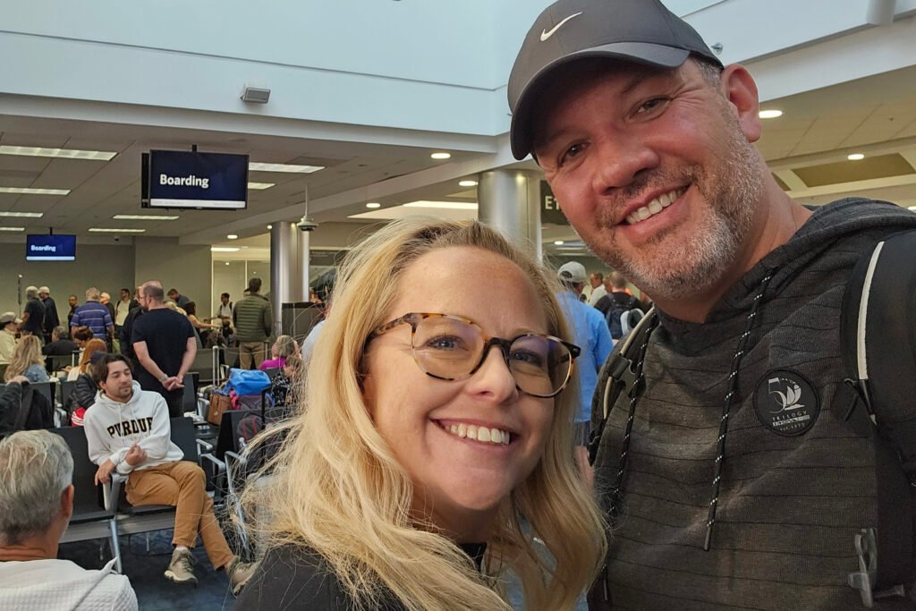Man and woman smiling in airport