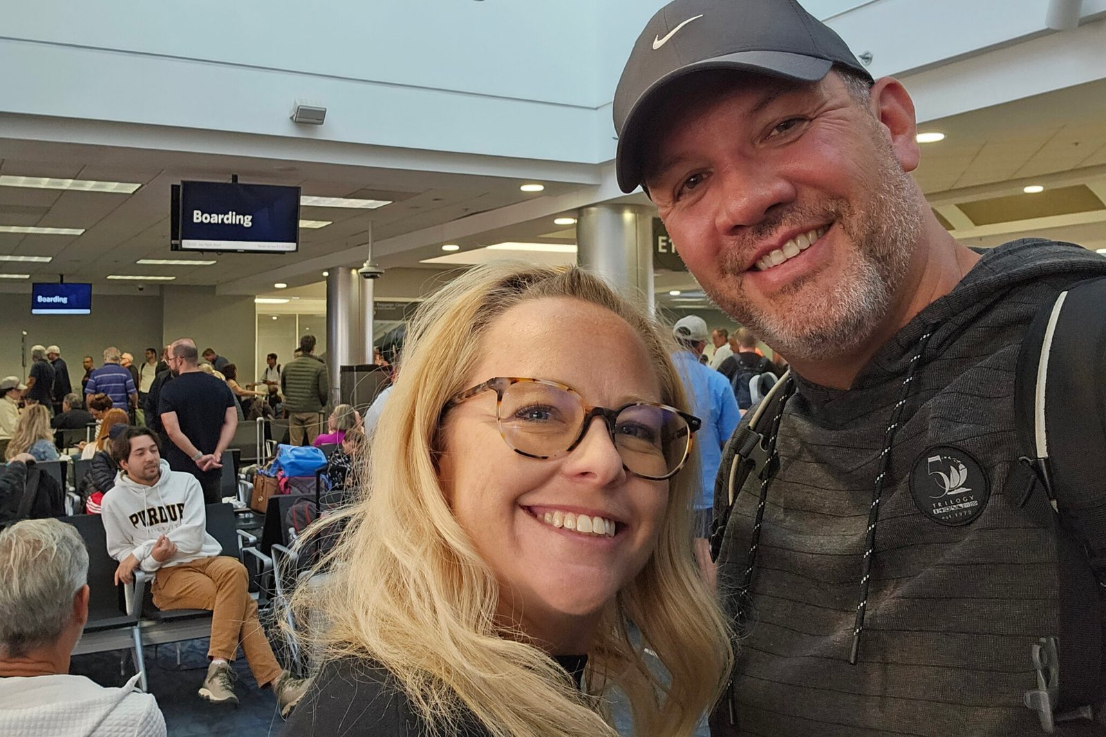 Man and woman smiling in airport