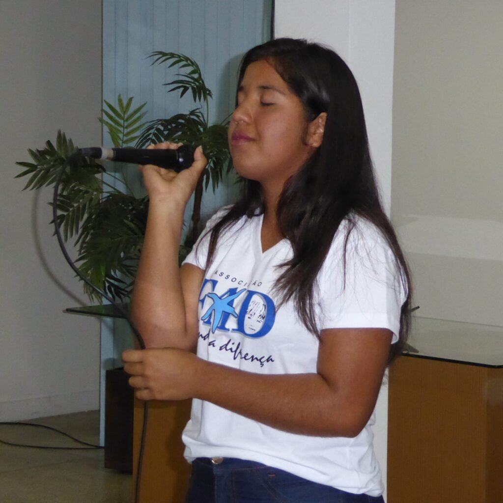 joanna-story-2 young girl in FAD tshirt singing into a microphone during worship