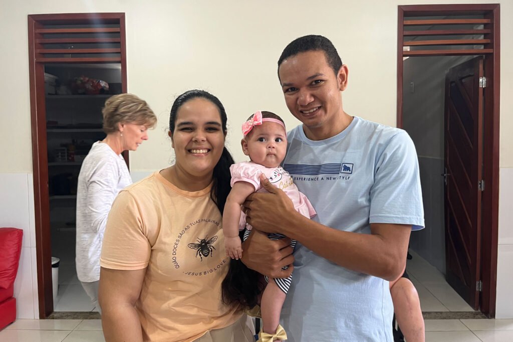 Man, wife and child all smiling at FAD center